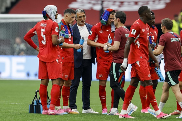 From left: Switzerland's Manuel Akanji, Switzerland's Granit Xhaka, Switzerland's head coach Murat Yakinand Switzerland's Nico Elvedi speak during a Hydration Break during the Worl ...