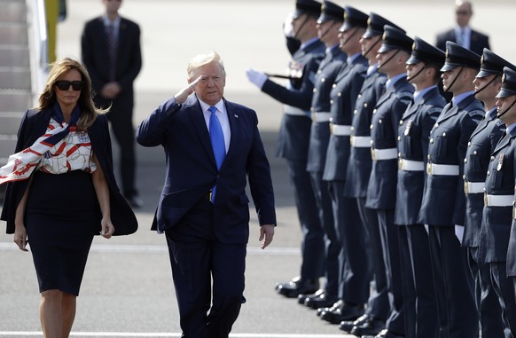 President Donald Trump salutes an honor guard as he and first lady Melania Trump arrive at Stansted Airport in England, Monday, June 3, 2019 at the start of a three day state visit to Britain. (AP Pho ...