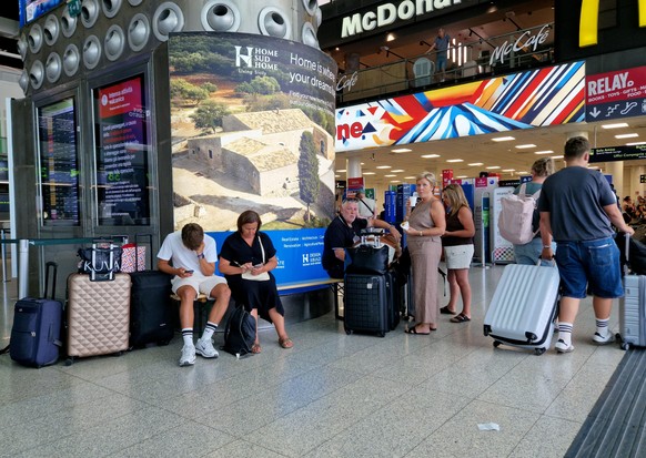 epa13164030 Travelers at Catania Airport, in Catania, Italy, 12 August 2026. All flights arriving at and departing from Catania Airport have been suspended until 4:00 PM on 13 August due to heavy ashf ...