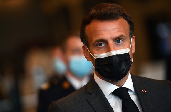 French President Emmanuel Macron talks to the press as he visits a giant vaccination center against the Covid-19 during its inauguration at Porte de Versailles convention centre in Paris, Thursday, Ma ...