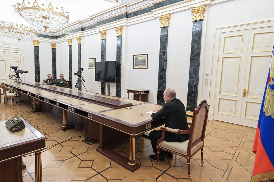 Russian President Vladimir Putin, right, speaks to Russian Defense Minister Sergei Shoigu, second left, and Head of the General Staff of the Armed Forces of Russia and First Deputy Defense Minister Va ...