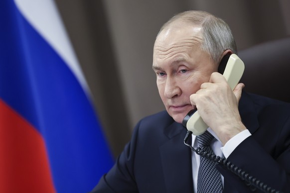 FILE - Russian President Vladimir Putin speaks on the phone with Taisia Leonova, a girl from the Moscow region, as part of a nationwide charity campaign fulfilling children&#039;s Christmas wishes in  ...