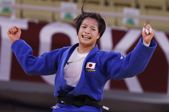 epa09364358 Uta Abe of Japan reacts after defeating Amandine Buchard of France during their bout in the Women&#039;s -52kg Final Judo events of the Tokyo 2020 Olympic Games at the Nippon Budokan arena ...