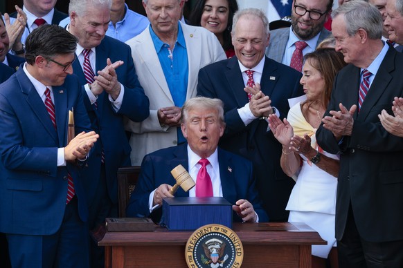 epaselect epa12216778 US President Donald J. Trump, with the gavel Speaker of the House Mike Johnson (L) gave him, after signing his &#039;Big Beautiful Bill&#039; into law during the Independence Day ...