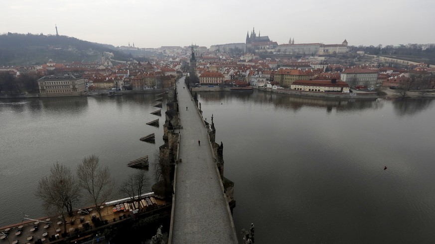 A view of the near empty Charles Bridge in Prague, Czech Republic, Friday, March 20, 2020. The Czech Republic's government has approved further dramatic measures to try and stem the spread of the ...