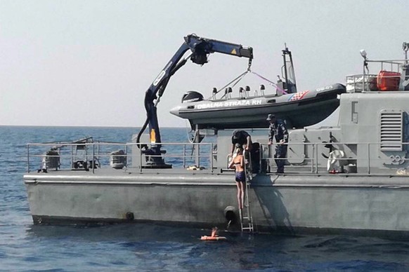 epa06960646 A handout photo made available by the Croatian Coast Guard on 20 August 2018 shows a British woman being rescued by the coastguard patrol boat the Cavtat at sea in the Adriatic, off the co ...