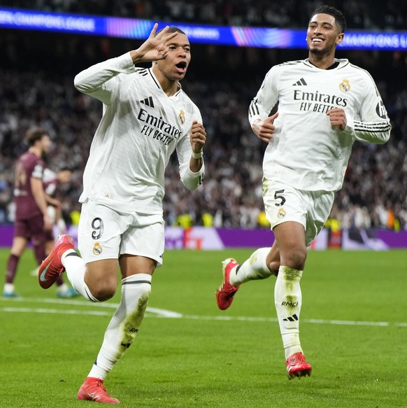Real Madrid&#039;s Kylian Mbappe celebrates with Real Madrid&#039;s Jude Bellingham, right, after scoring his sides third goal during the Champions League playoff second leg soccer match between Real  ...