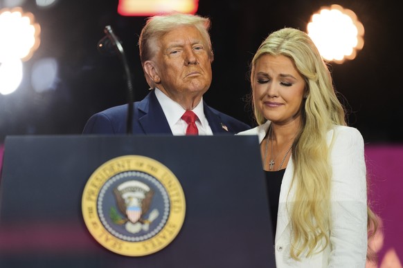 President Donald Trump, left, stands with Erika Kirk at the conclusion of a memorial for her husband, conservative activist Charlie Kirk, Sunday, Sept. 21, 2025, at State Farm Stadium in Glendale, Ari ...