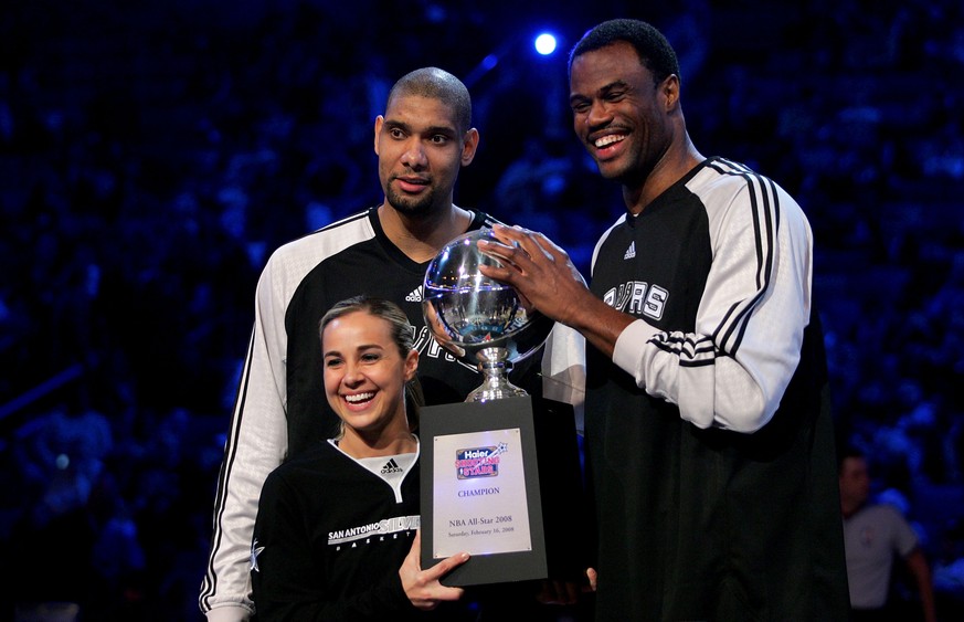 NEW ORLEANS - FEBRUARY 16: Tim Duncan of the San Antonio Spurs, NBA legend David Robinson and WNBA player Becky Hammon of the San Antonio Silver Star pose with the championship trophy after winning th ...