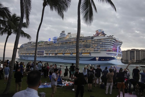 People film and wave from South Pointe Park, as Icon of the Seas, the world&#039;s largest cruise ship, sails out of PortMiami on its first public cruise, in Miami Beach, Fla., Saturday, Jan. 27, 2024 ...