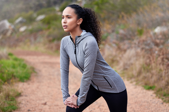 Runner, stretching or woman on trail for workout, training or exercise with mobility or healthy body. Mountain, sports person and girl in nature running, hiking and wellness for fitness and break Runn ...