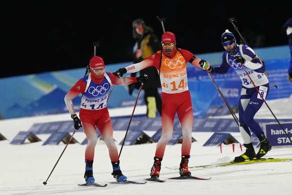 Benjamin Weger of Switzerland, right, tags teammate Sebastian Stalder during the 4x6-kilometer mixed relay at the 2022 Winter Olympics, Saturday, Feb. 5, 2022, in Zhangjiakou, China. (AP Photo/Kirsty  ...