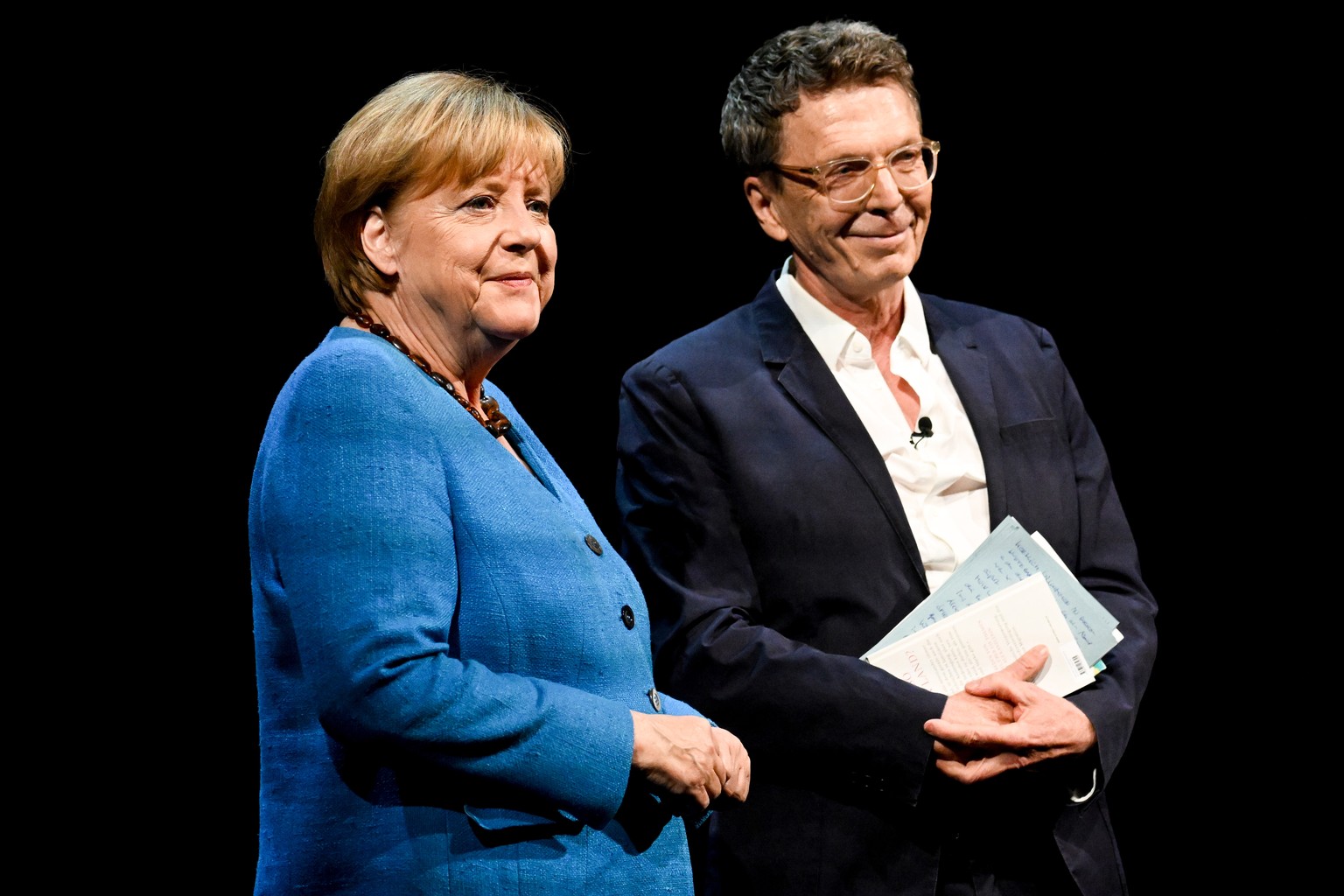 epa10000942 Former German Chancellor Angela Merkel (L) during &#039;So what is my country?&#039; conversation with Alexander Osang (R) at the Berliner Ensemble in Berlin, Germany, 07 June 2022. EPA/FI ...