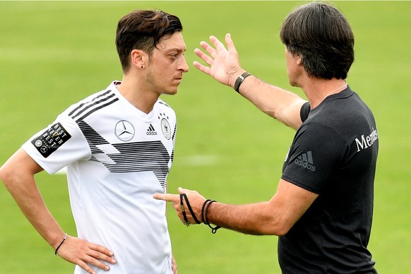 epa06759652 German national soccer team head coach Joachim Loew (R) talks to Mesut Oezil (L) during a training session in Eppan, Italy, 24 May 2018. The German squad prepares for the upcoming FIFA Wor ...