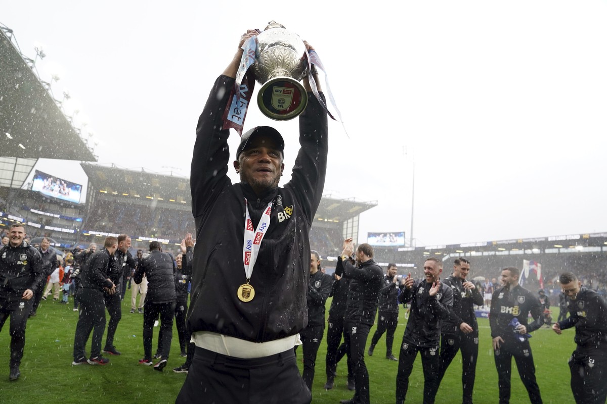 Burnley manager Vincent Kompany lifts the trophy after the English Football League Championship soccer match against Cardiff City at Turf Moor, Burnley, England, Monday, May 8, 2023. (Martin Rickett/P ...