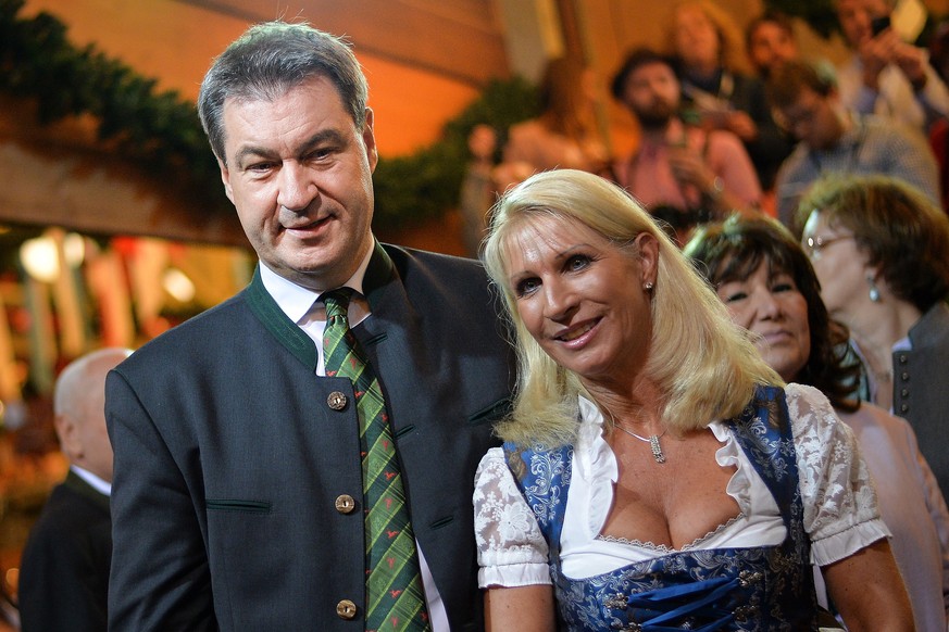 epa07038907 Bavarian prime minister Markus Soeder (CSU) and his wife Karin Baumueller pose for a picture during the opening day of the 185th Oktoberfest beer festival in Munich, Germany, 22 September  ...