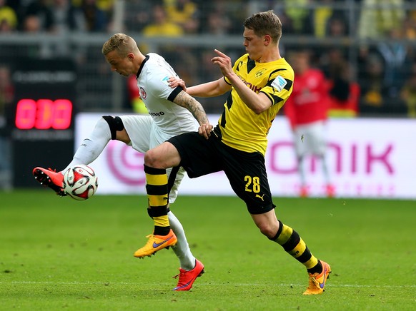 DORTMUND, GERMANY - APRIL 25: Matthias Ginter (R) of Dortmund and Sonny Kittel of Frankfurt battle for the ball during the Bundesliga match between Borussia Dortmund and Eintracht Frankfurt at Signal  ...