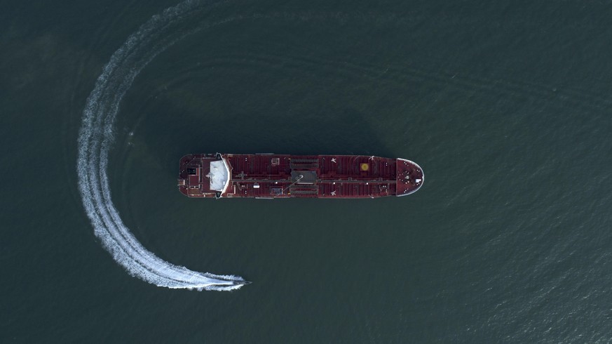 In this Sunday, July 21, 2019 photo, an aerial view shows a speedboat of Iran&#039;s Revolutionary Guard moving around the British-flagged oil tanker Stena Impero which was seized in the Strait of Hor ...