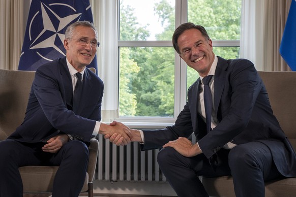 FILE - NATO Secretary General Jens Stoltenberg, left, and Dutch Prime Minister Mark Rutte shake hands for the cameras prior to a meeting in The Hague, Netherlands, Tuesday, June 27, 2023. NATO on Wedn ...