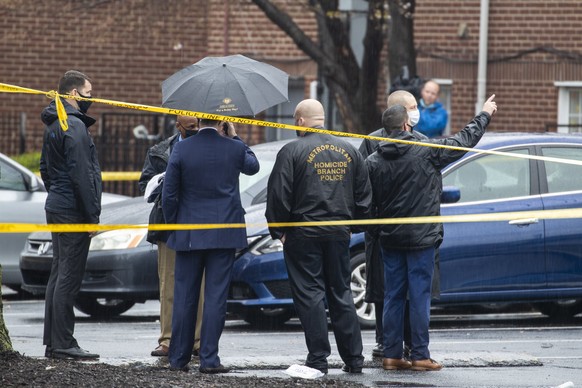 epa09109481 Metropolitan Police officers on scene of a shooting in Southeast Washington, DC, USA, 31 March 2021. Two people are dead and three people are suffering non-life threatening injuries after  ...