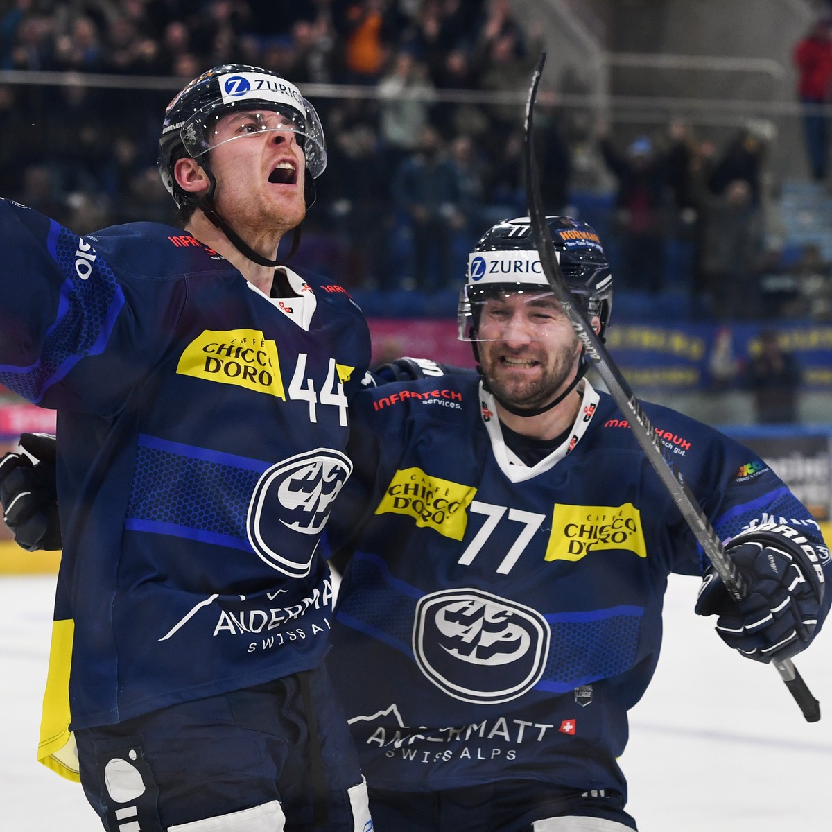 Ambri's player Andre Heim celebrates the 4-4 goal, left, with Ambri's player Yanik Burren, right, during the match of National League Swiss Championship 2022/23 between HC Ambri Piotta and E ...