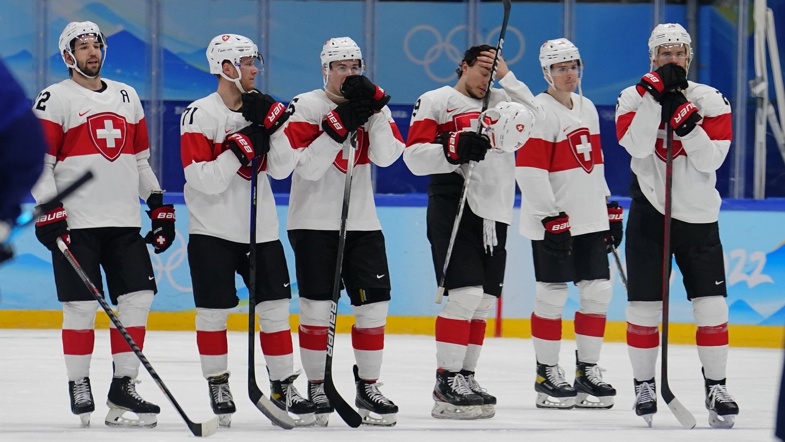 Team Switzerland players line up following a 5-1 loss to Finland in a men&#039;s quarterfinal hockey game at the 2022 Winter Olympics, Wednesday, Feb. 16, 2022, in Beijing. (AP Photo/Matt Slocum)