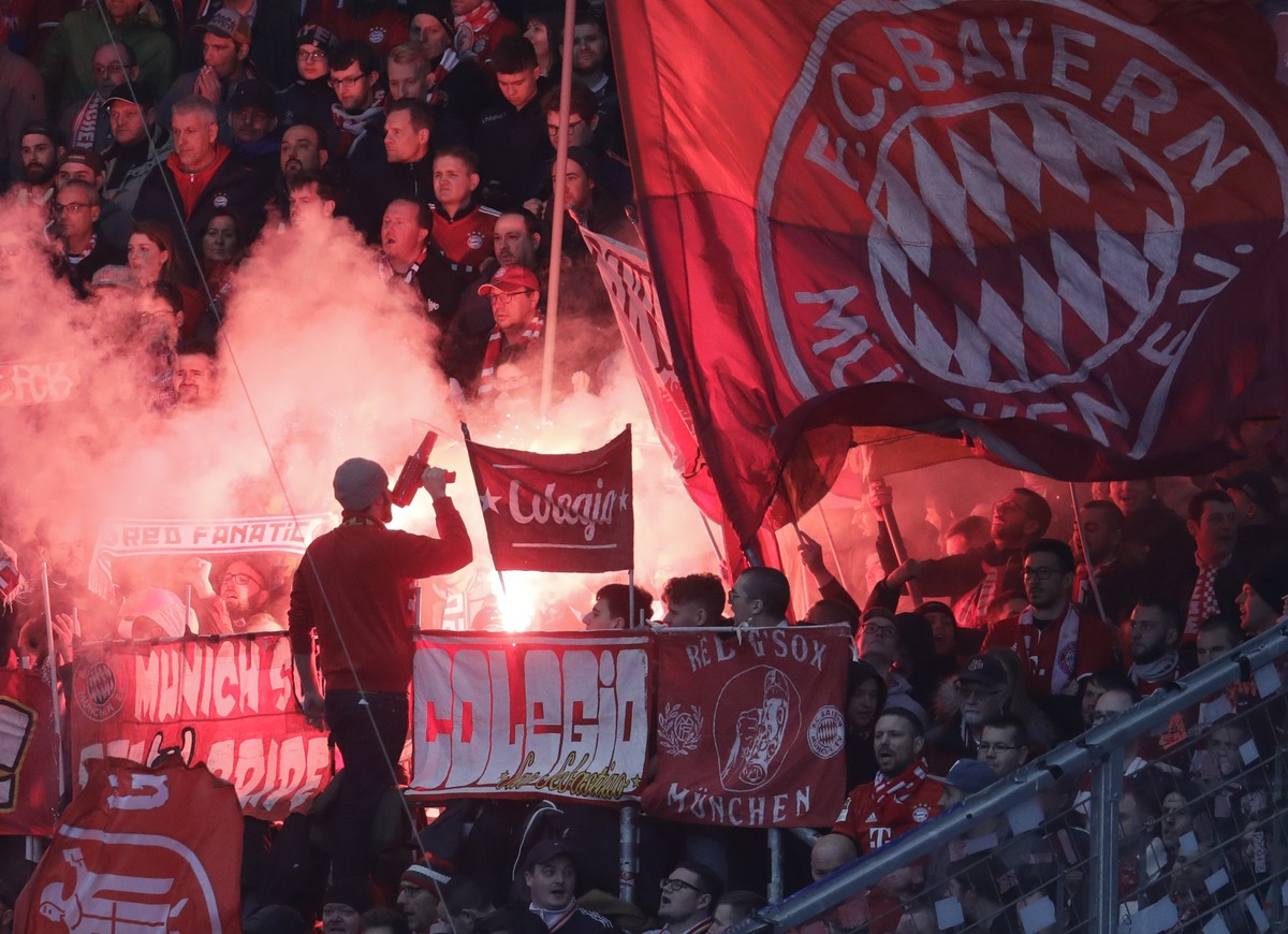 Bayern's fans light flares during a German Bundesliga soccer match between TSG 1899 Hoffenheim and Bayern Munich in Sinsheim, Germany, Saturday, Feb. 29, 2020. (AP Photo/Michael Probst)