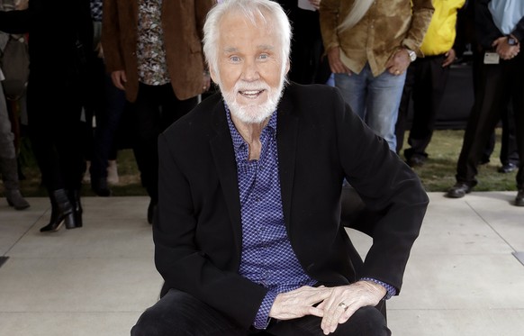 FILE - In this Oct. 24, 2017 file photo, Kenny Rogers poses with his star on the Music City Walk of Fame in Nashville, Tenn. Actor-singer Kenny Rogers, the smooth, Grammy-winning balladeer who spanned ...