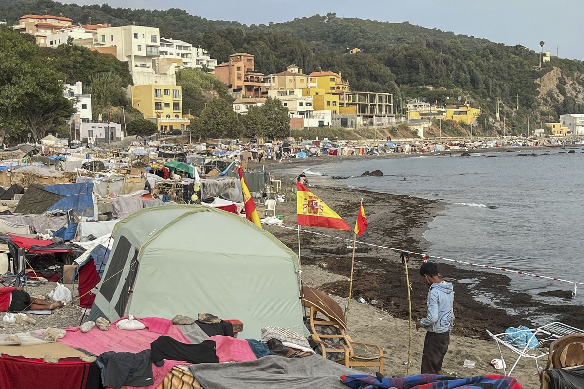 epa13216498 A migrant stands near makeshift tents erected by migrants along Trampolin Beach in Ceuta, Spain, 06 September 2026. Ceuta President Juan Jesus Vivas is expected to meet European Commission ...