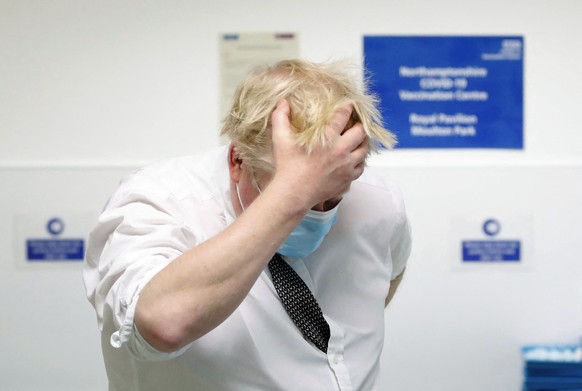 Britain&#039;s Prime Minister Boris Johnson gestures, during a visit to a COVID-19 vaccination centre, in Northampton, England, Thursday, Jan. 6, 2022. (Peter Cziborra/Pool Photo via AP)