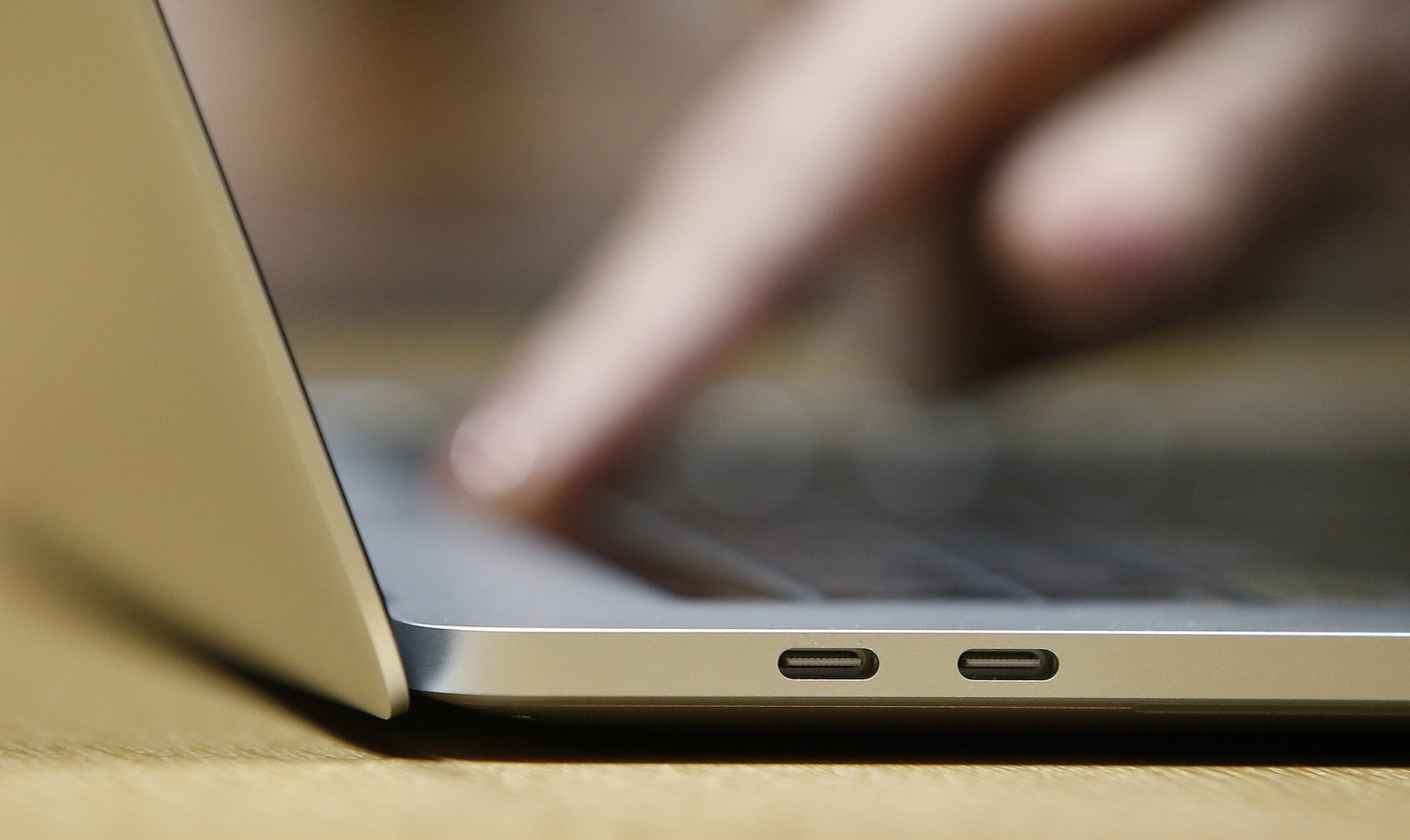 epa06417905 (FILE) - A guest inspects the new MacBook Pro computer with the new USB-C ports in a demo room, following the announcement of new products at the Apple Headquarters in Cupertino, Californi ...