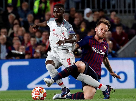 epa07541211 FC Barcelona&#039;s midfielder Ivan Rakitic (R) duels for the ball against Liverpool&#039;s midfielder Naby Keita (L) during the UEFA Champions League first leg semifinal match between FC  ...