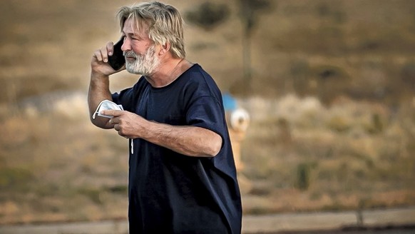 Alec Baldwin speaks on the phone in the parking lot outside the Santa Fe County Sheriff's Office in Santa Fe, NM, after being questioned about a shooting on the set of the film "Rust
