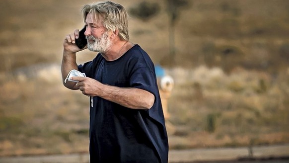 Alec Baldwin speaks on the phone in the parking lot outside the Santa Fe County Sheriff&#039;s Office in Santa Fe, N.M., after he was questioned about a shooting on the set of the film &quot;Rust&quot ...