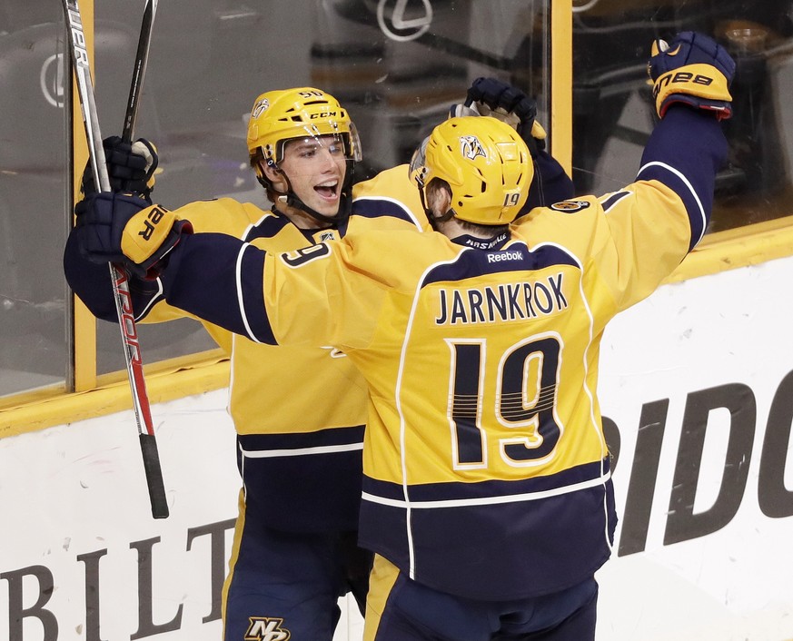Nashville Predators left wing Kevin Fiala, top, of Switzerland, celebrates with Calle Jarnkrok (19), of Sweden, after Fiala scored against the Pittsburgh Penguins during the second period of an NHL ho ...