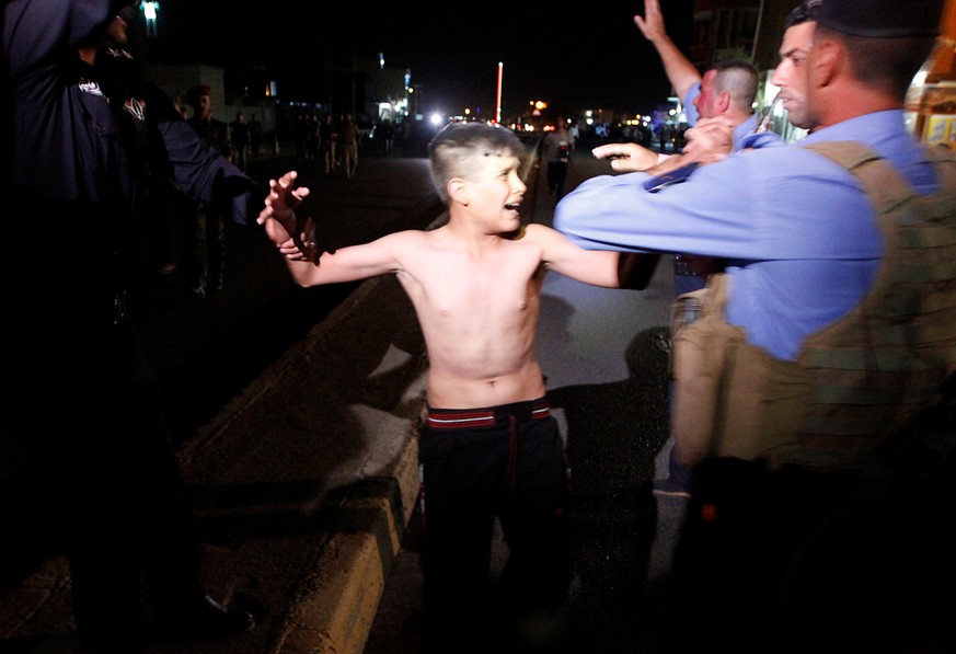 Iraqi security forces detain a boy after removing a suicide vest from him in Kirkuk, Iraq, August 21, 2016. REUTERS/Ako Rasheed TPX IMAGES OF THE DAY