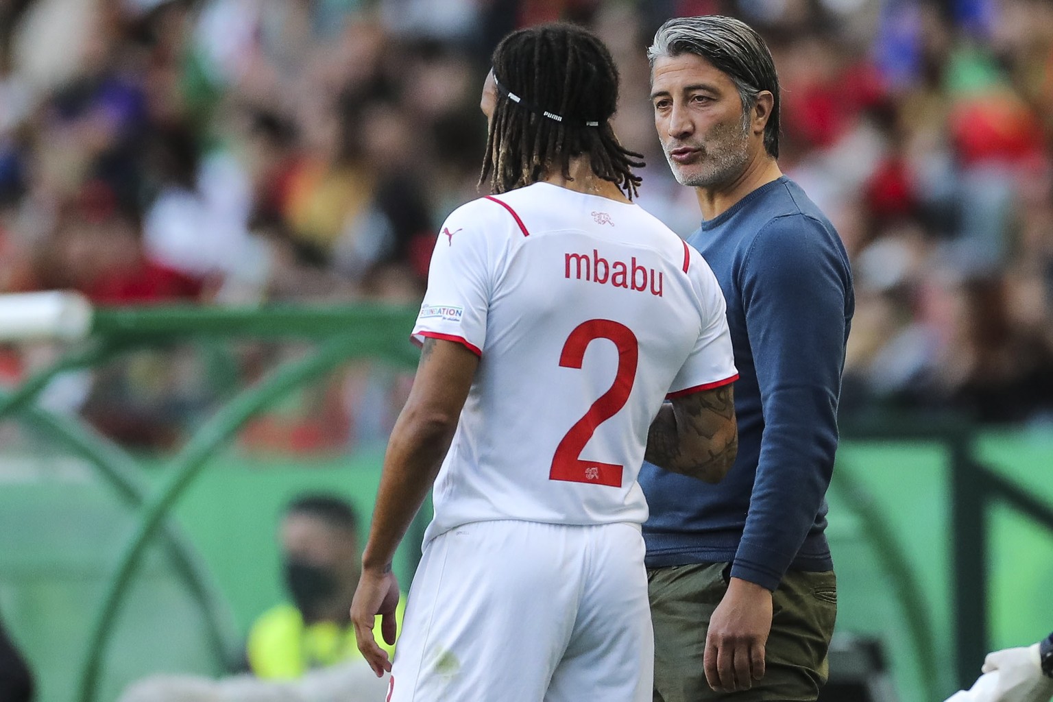 epa09998068 Switzerland&#039;s head coach Murat Yakin (R) gives instructions to Kevin Mbabu (L) during the UEFA Nations League soccer match between Portugal and Switzerland in Lisbon, Portugal, 05 Jun ...