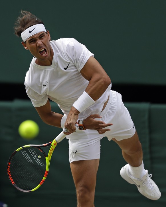 Spain&#039;s Rafael Nadal serves to Switzerland&#039;s Roger Federer in a Men&#039;s singles semifinal match on day eleven of the Wimbledon Tennis Championships in London, Friday, July 12, 2019. (AP P ...