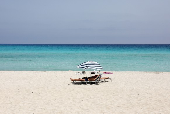 epa08482602 People enjoy the sun and the sea on a beach in Ayia Napa in the southeastern coast, after the opened up of airports following a nationwide lockdown amid the spread of the coronavirus Covid ...