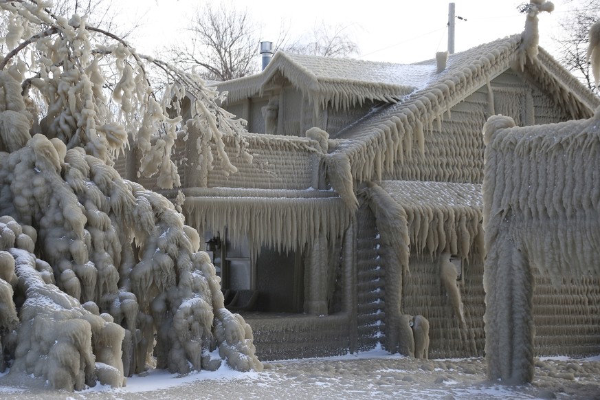 Houses along Hoover Beach is covered by ice from high winds and from the waves from Lake Erie, Saturday, Feb. 29, 2020, in Hamburg N.Y. Blowing snow has fallen around the state since Thursday, though  ...