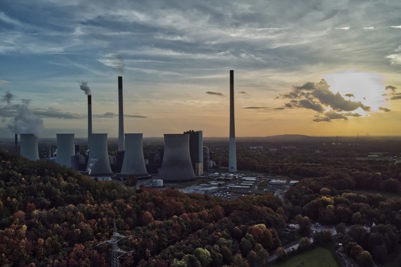 FILE - The sun sets behind the cole-fired power plant &#039;Scholven&#039; of the Uniper energy company in Gelsenkirchen, Germany, on Oct. 22, 2022. Germany&#039;s economy shrank 0.3% last year as Eur ...