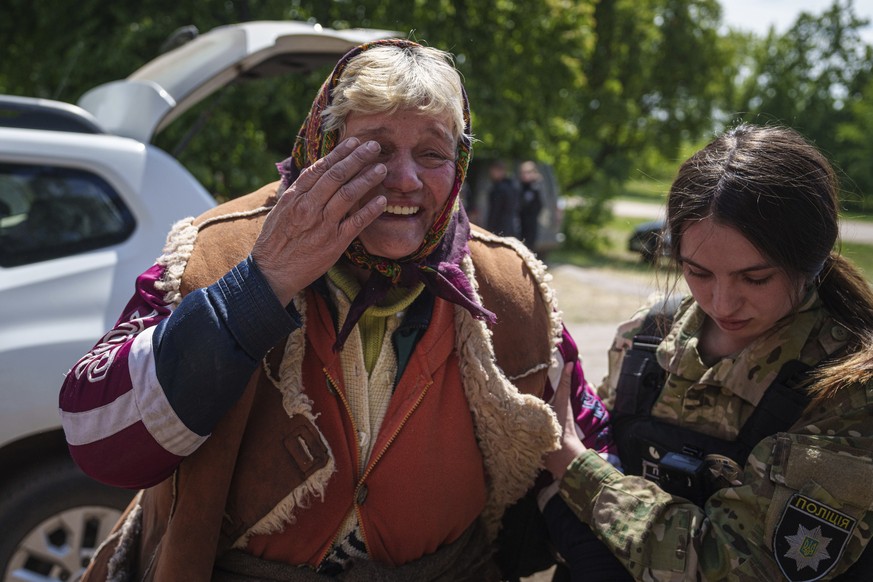 A woman cries as she is being evacuated from Vovchansk, Ukraine, Saturday, May 11, 2024. (AP Photo/Evgeniy Maloletka)
