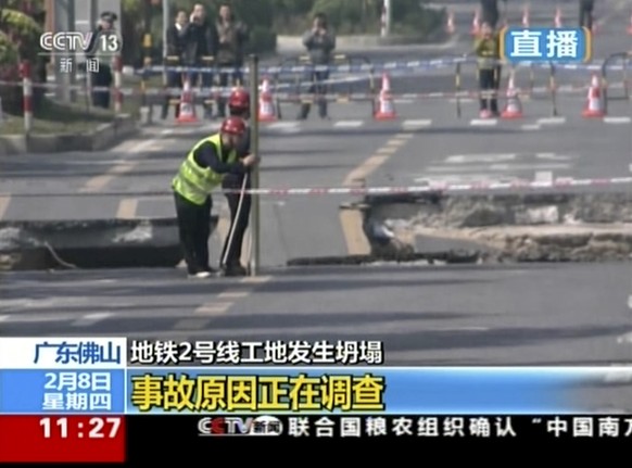In this image taken from video footage run by China&#039;s CCTV via AP Video, officials work at the site of a road collapse in Foshan, southern China&#039;s Guangdong Province, Thursday, Feb. 8, 2018. ...