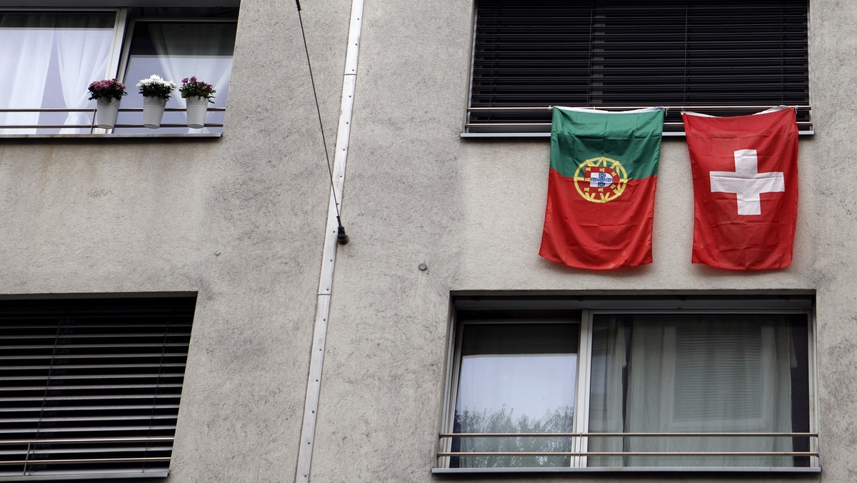 Portugal's flag and Switzerland's flag hang on a window of an apartment building during the Euro 2016 European Soccer Championships, in Geneva, Switzerland, Sunday, June 12, 2016. (KEYSTONE/ ...