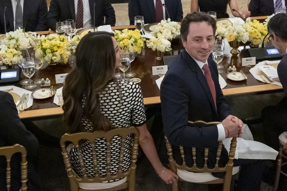 Sergey Brin, right turning around, a Google founder, and Gerelyn Gilbert-Soto, left, are seated during a dinner with President Donald Trump in the State Dining Room of the White House, Thursday, Sept. ...
