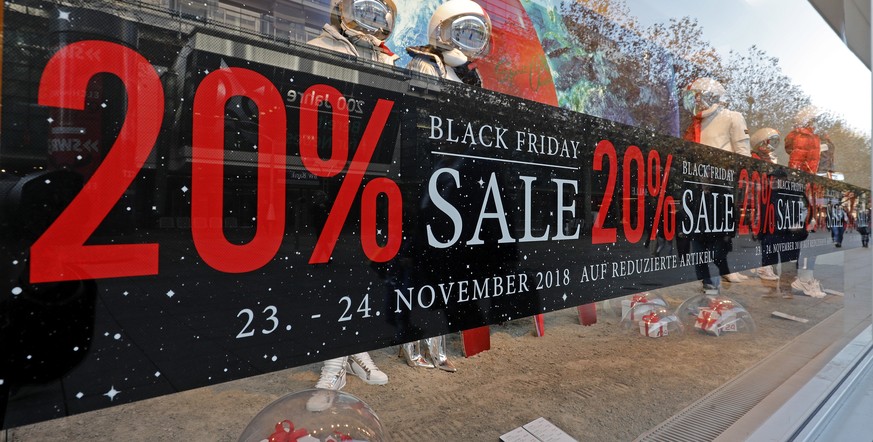 epa07184061 A poster with the letters &#039;Black Friday&#039; hangs on a shop window at a store in Stuttgart, Germany, 23 November 2018. Black Friday sale is annually held on the fourth Thursday in N ...