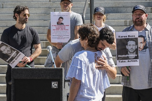 Micah Parker &quot;Vampire Diaries,&quot; actor, producer, and organizer of Justice for Johnny Wactor, hugs Johnny&#039;s mother, Scarlett Wactor, during a news conference outside Los Angeles City Hal ...