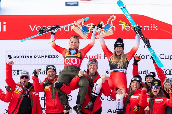 epa11836203 Second placed Lara Gut-Behrami (L) of Switzerland and her teammate third placed Corinne Suter (R) of Switzerland celebrate on the podium after the Women's SuperG race at the FIS Alpin ...