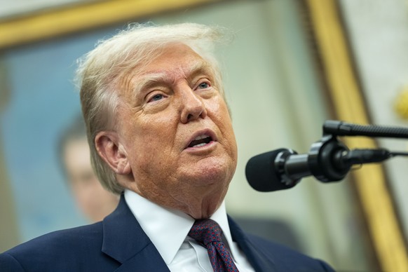 epa12287412 President Donald Trump and Apple CEO Tim Cook (not seen) announce an additional $100 billion Apple investment in the US in the Oval Office of the White House in Washington, DC, USA, 06 Aug ...
