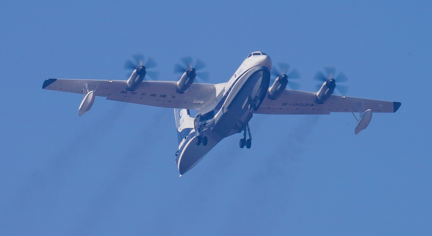 epa06404481 An AG600 amphibious aircraft takes off for its first test flight in Zhuhai, Guangdong province, China, 24 December 2017. The large amphibious flying boat, also known as TA-600, designed an ...